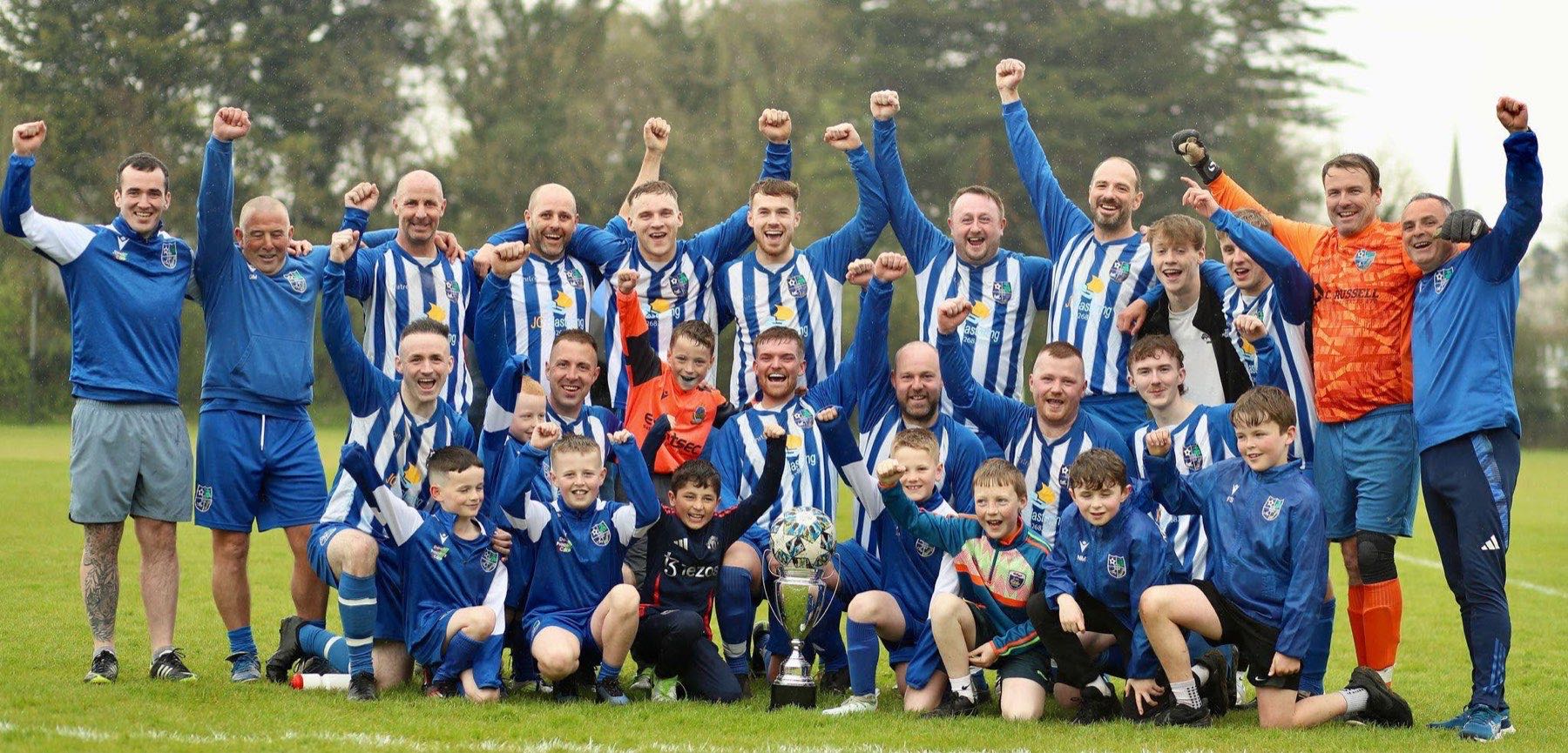 Kilmore Rec players and young supporters celebrating with a trophy