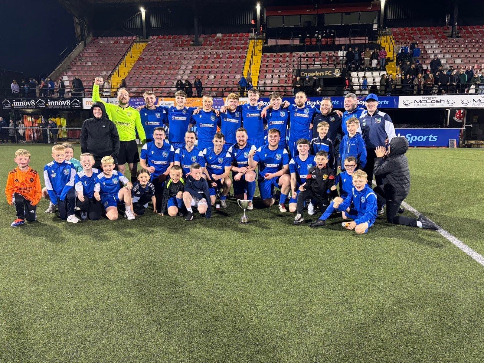 Kilmore Rec players celebrating with a trophy