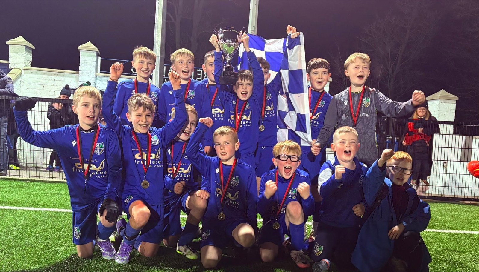 Youth cup celebrations under floodlights